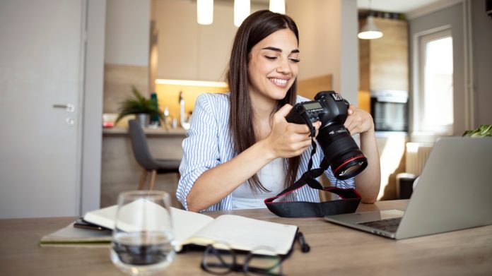 Happy,Young,Photographer,Holding,A,Dslr,Camera,In,Her,Home Best Camera Accessories